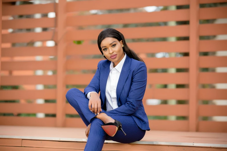 a woman with black hair and wearing a blue suit