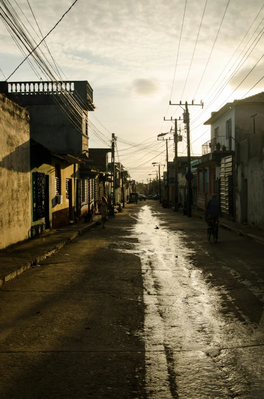 a street with a man riding his bike