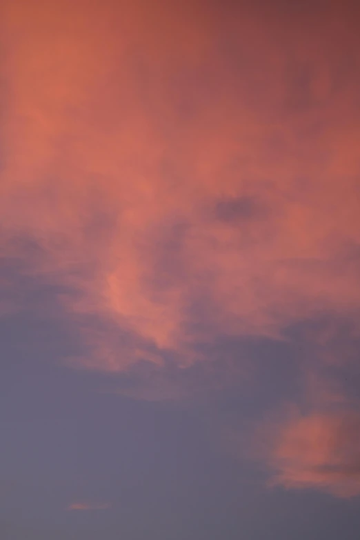 two jet planes are flying in front of red clouds