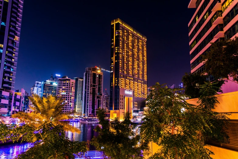 a night view of a city skyline, overlooking the river