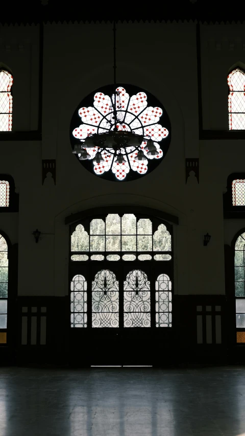 large ornate window in the middle of a building with many different stained glass windows