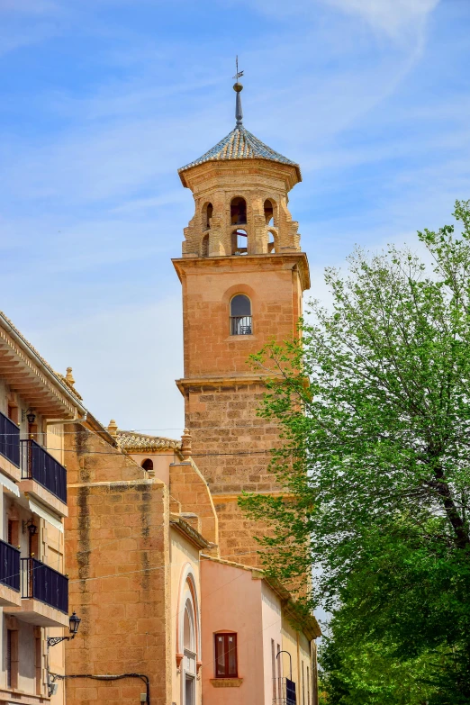 the tall brick clock tower has two turrets