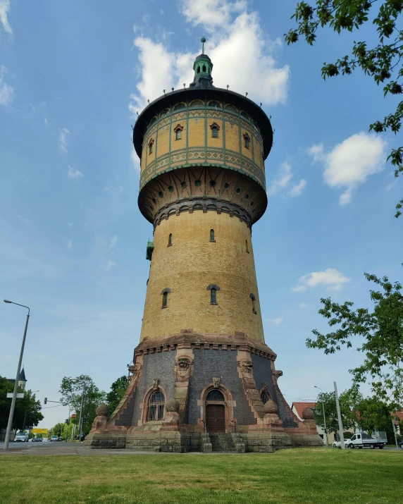 a very tall clock tower standing in a park