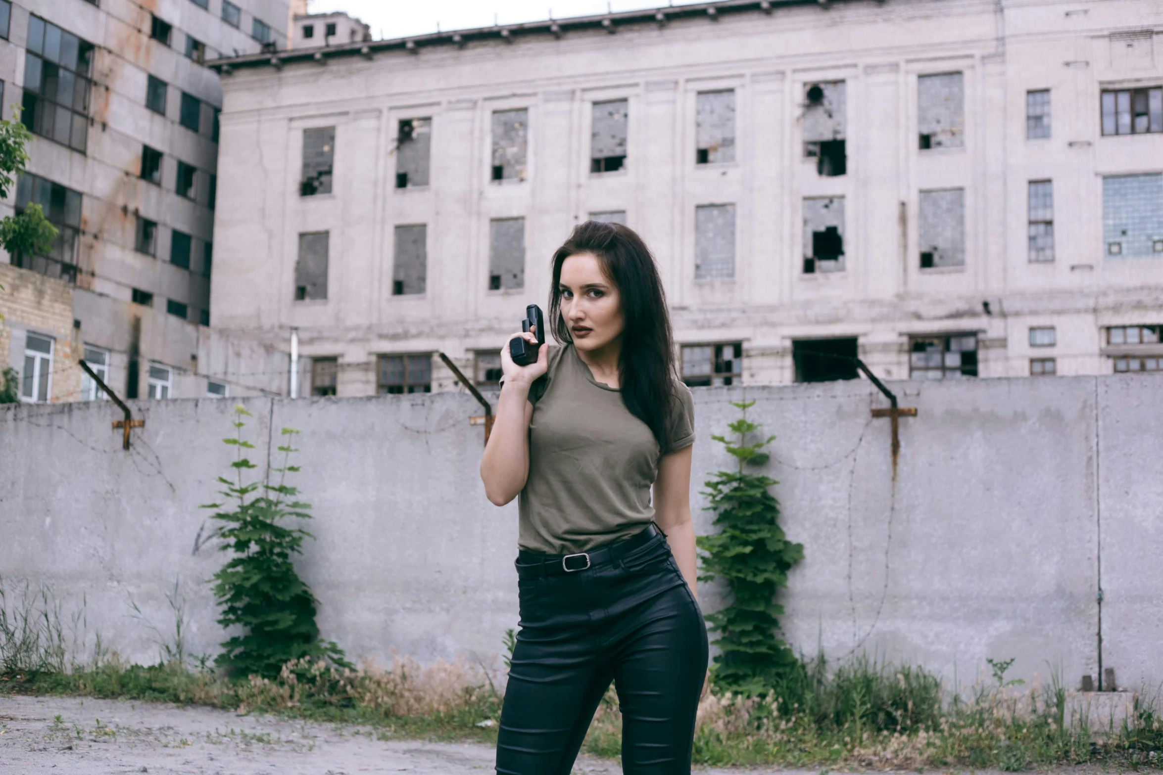 woman holding a cell phone near a building