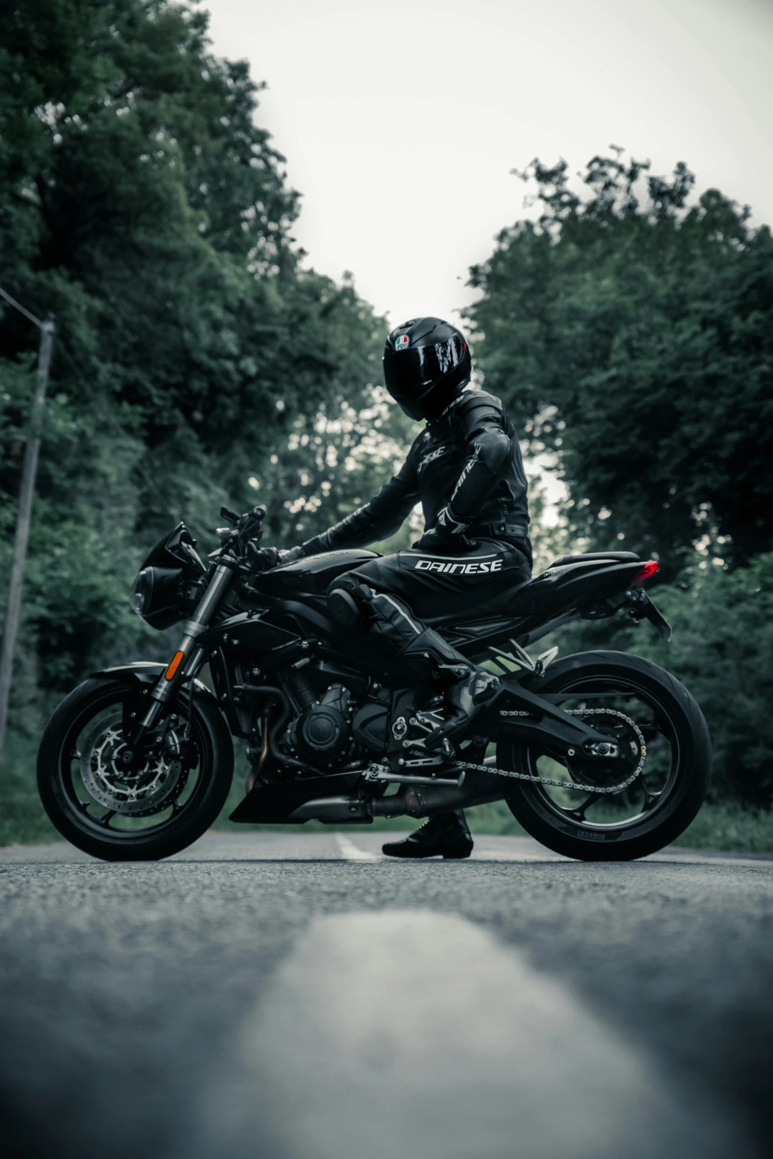 a black motorcycle that is on the side of a road