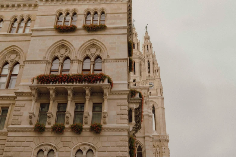 the building with flower boxes is a very tall clock tower