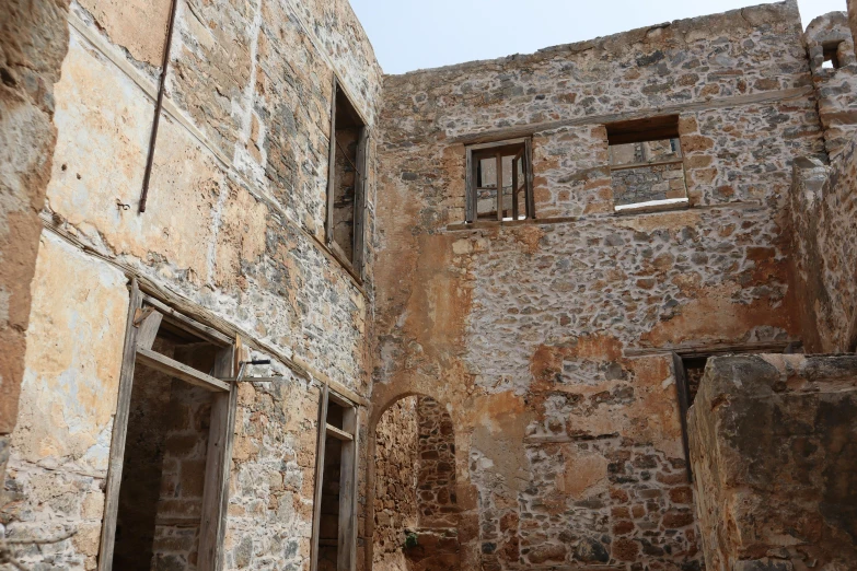 an image of a stone house with windows on the side