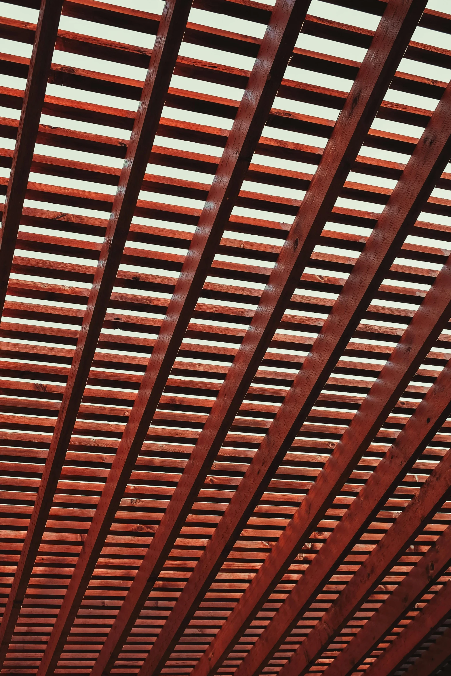 an open structure has many red wooden slats