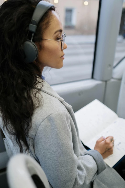 a woman with headphones on in a bus