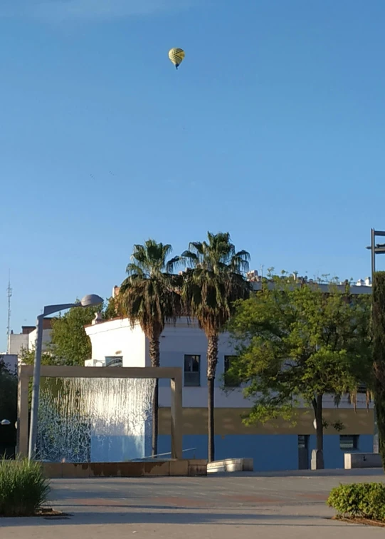 a  air balloon is being flown over a building