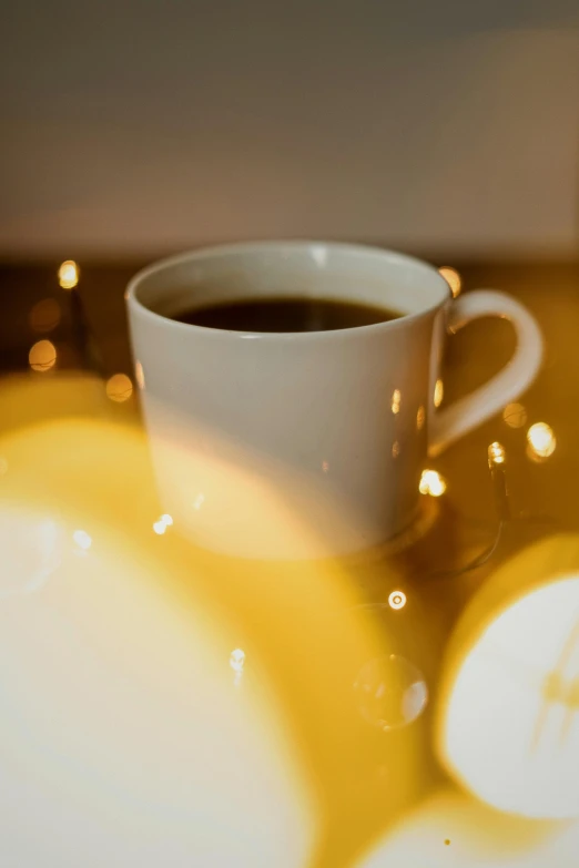 a white cup of coffee sitting on top of a table