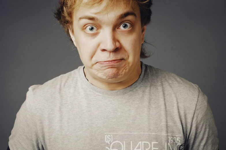 a close up of a man with an object in his mouth