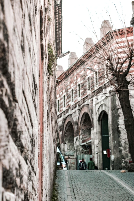 an alleyway on a city street in an old world area