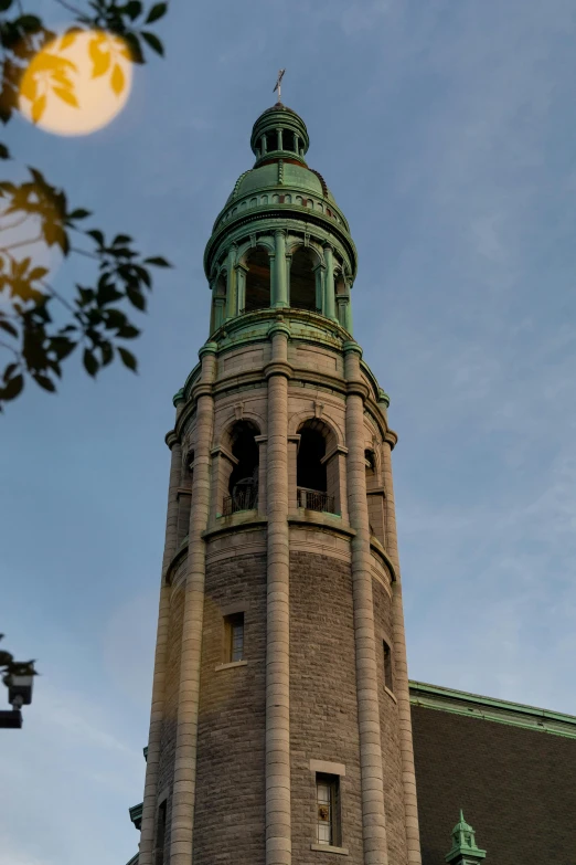 the tower with green trim has windows and a small window