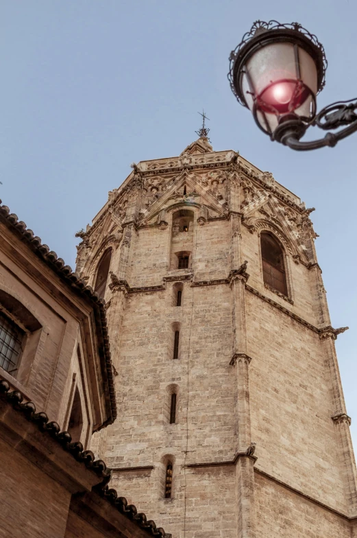 a clock tower with a red light below it