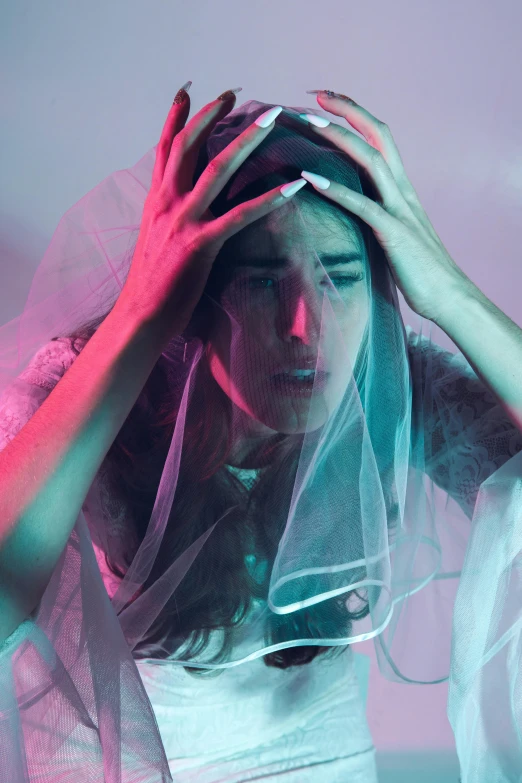 a young lady wearing a veil with hair net on her head and veil over her face