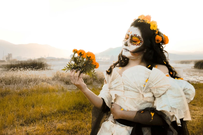 a woman holding a bunch of orange flowers