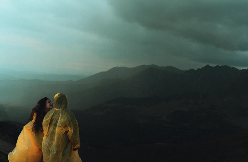 two people are standing together while looking at the night sky