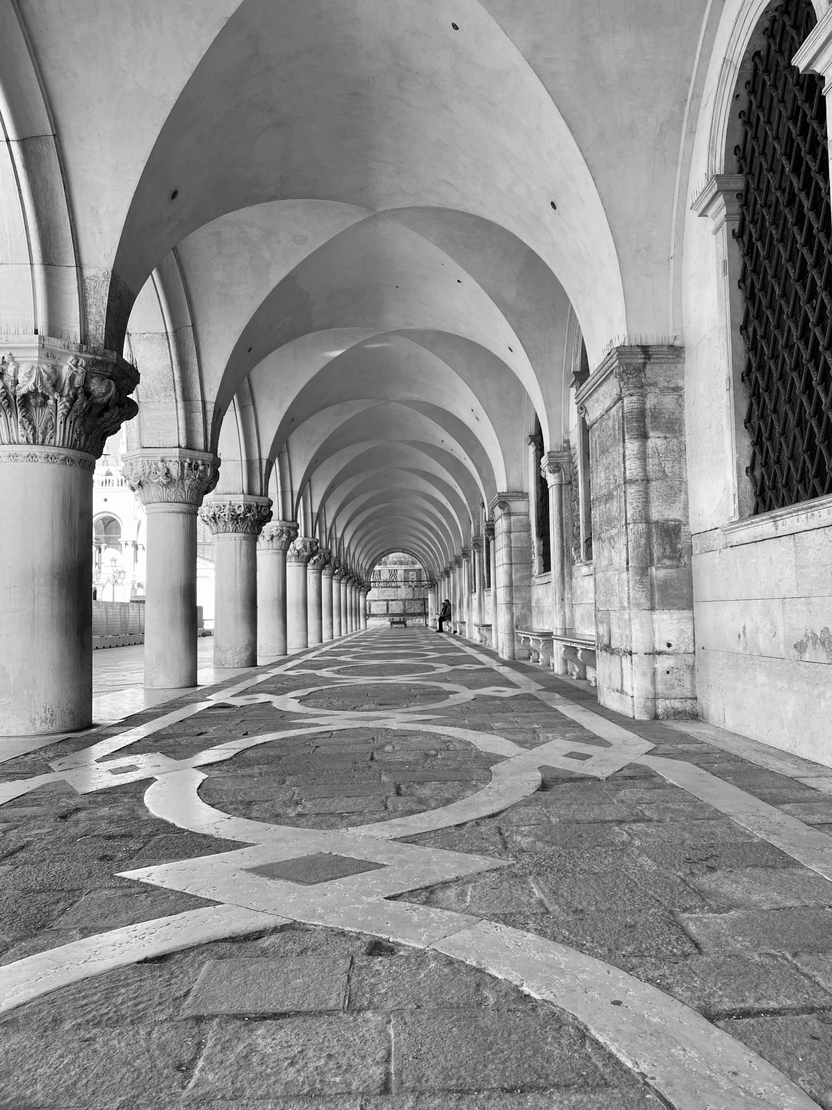 a large walkway inside of a building with arches