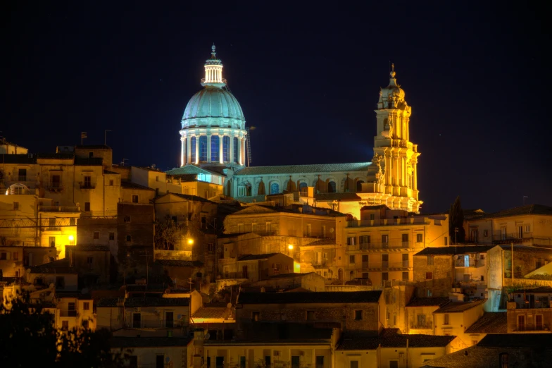 the dome of a building glows against the night sky