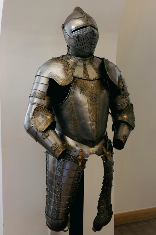 a silver costume sitting on top of a wooden floor