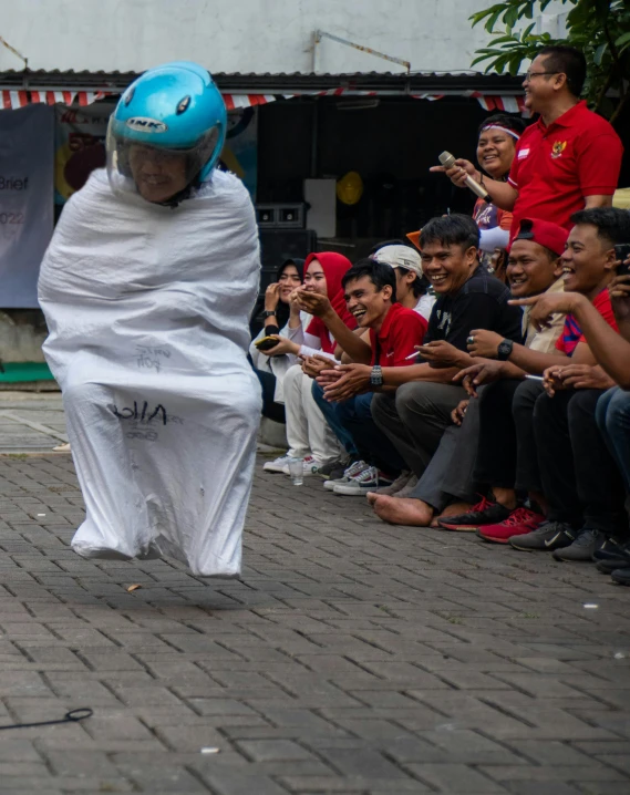 a person with a white cloth wrapped around his body on a stage