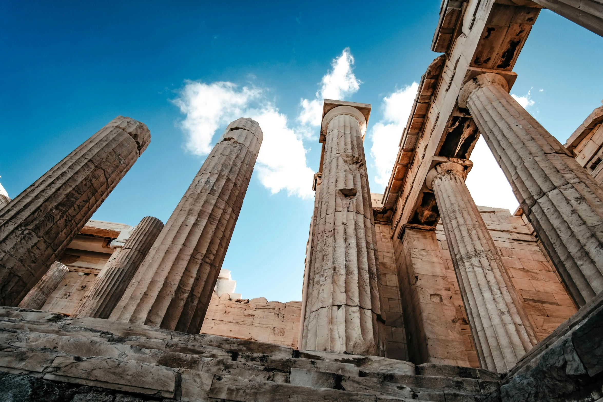 several large ancient ruins in front of a blue sky