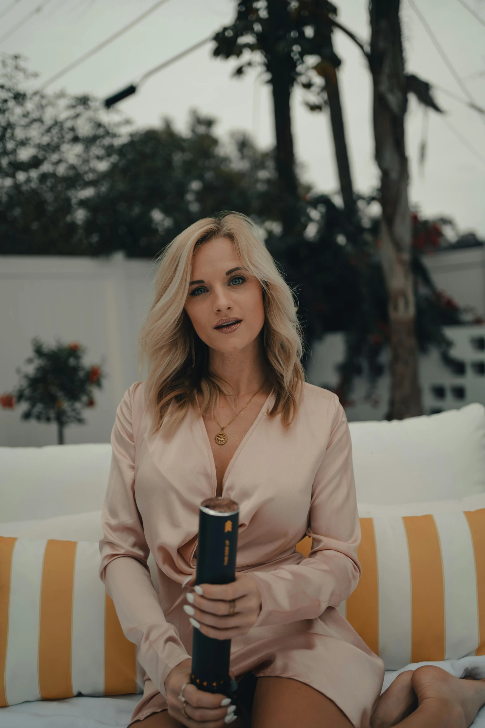 a woman sitting on a couch holding a microphone