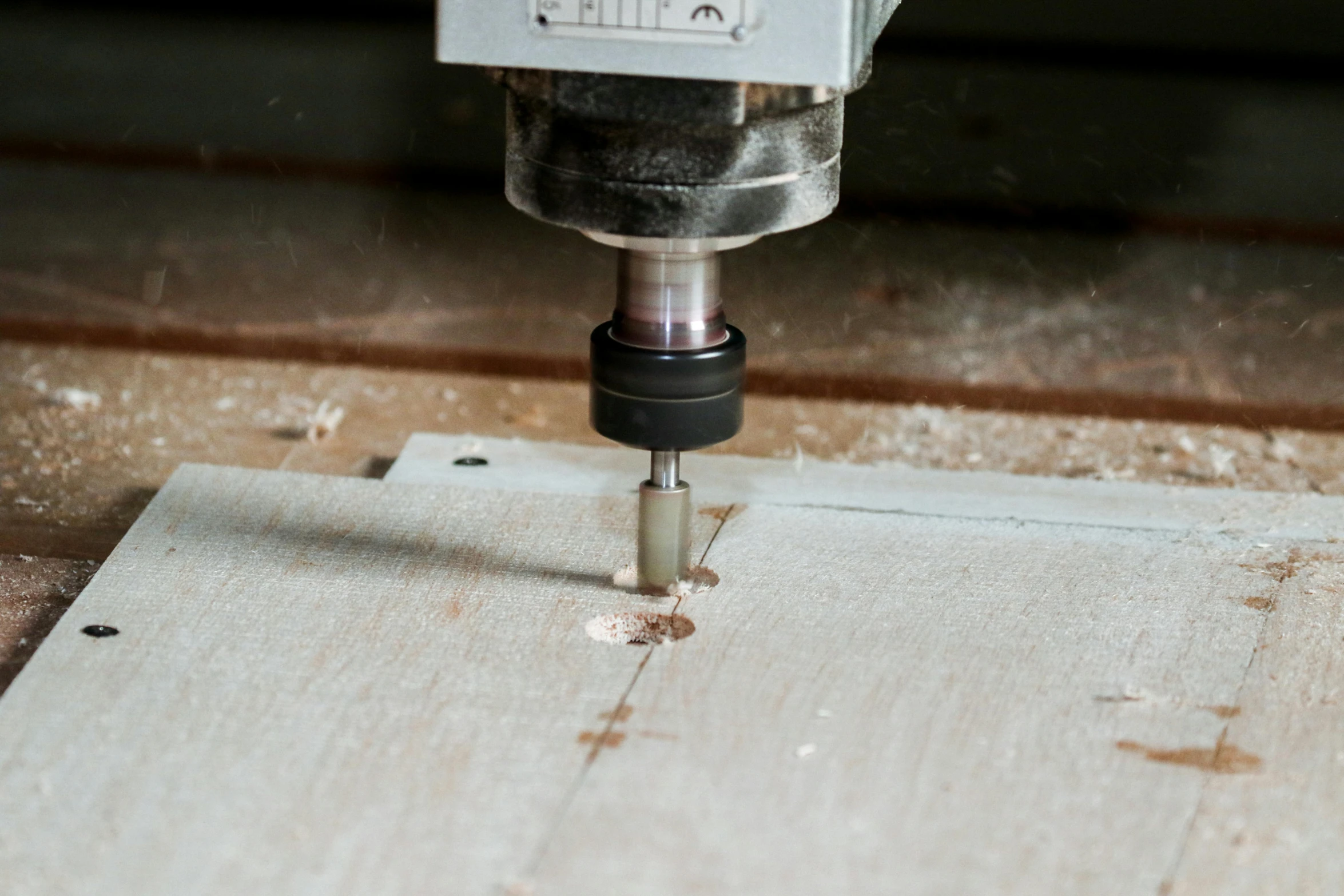 a drill with a hole in it on top of wooden floor