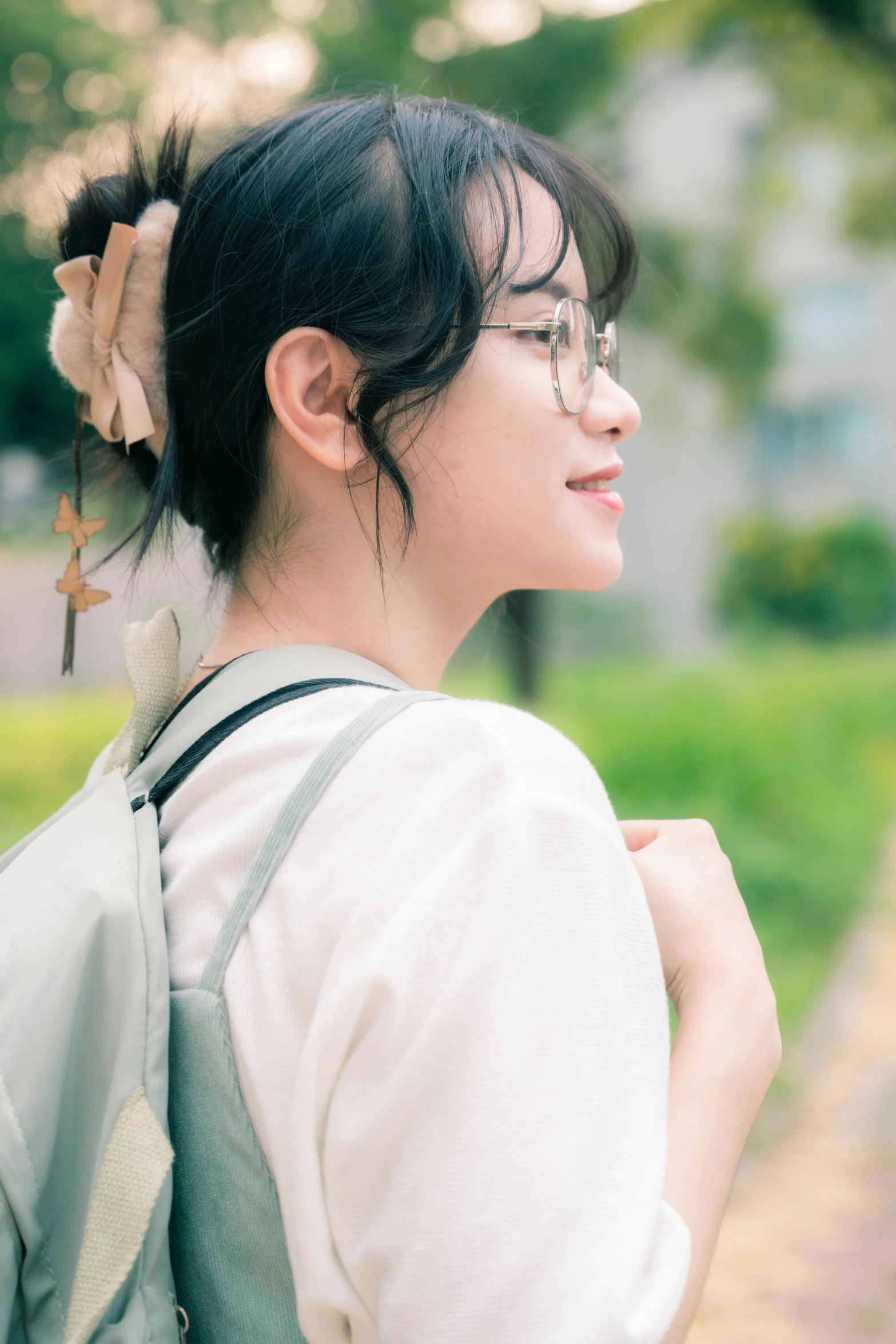 young woman with eyeglasses with a bookbag attached to her back