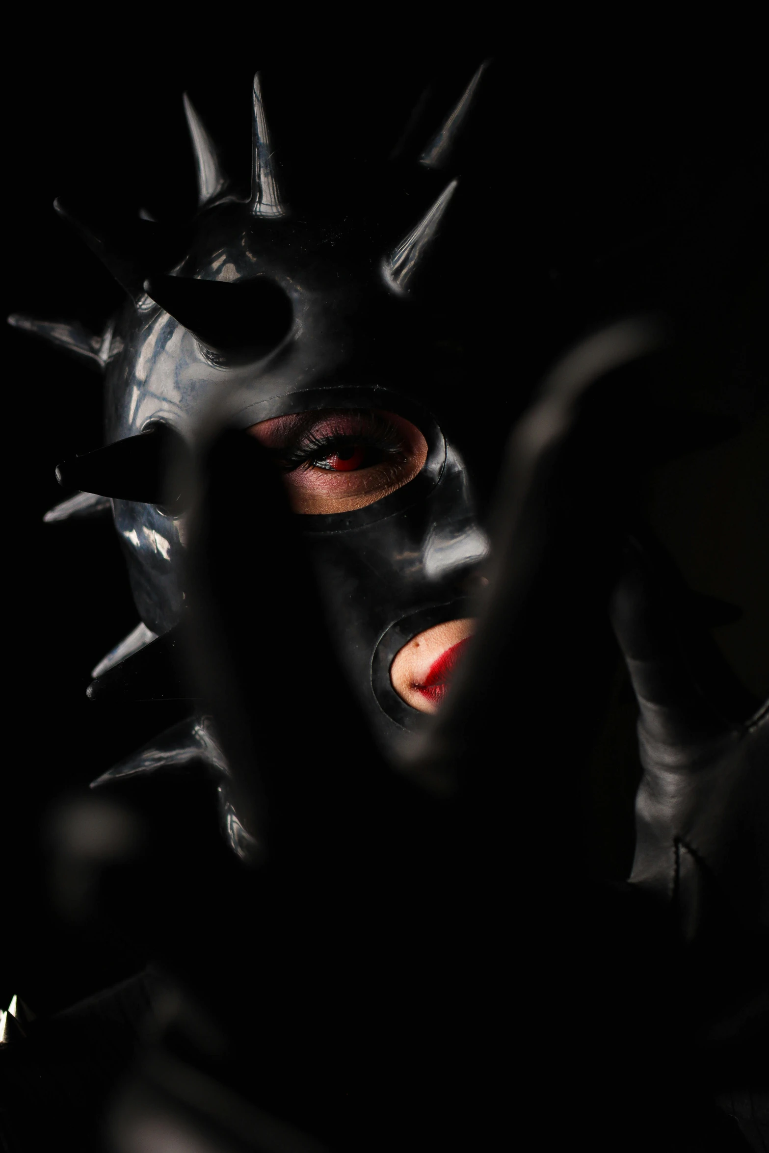 a masked man's face has spikes on its nose