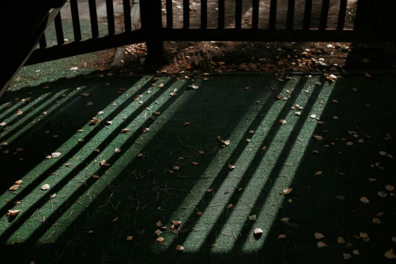 a bench in a dark room with long shadows