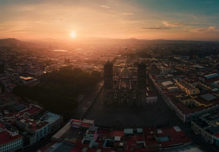 a sunset over an old city with many buildings