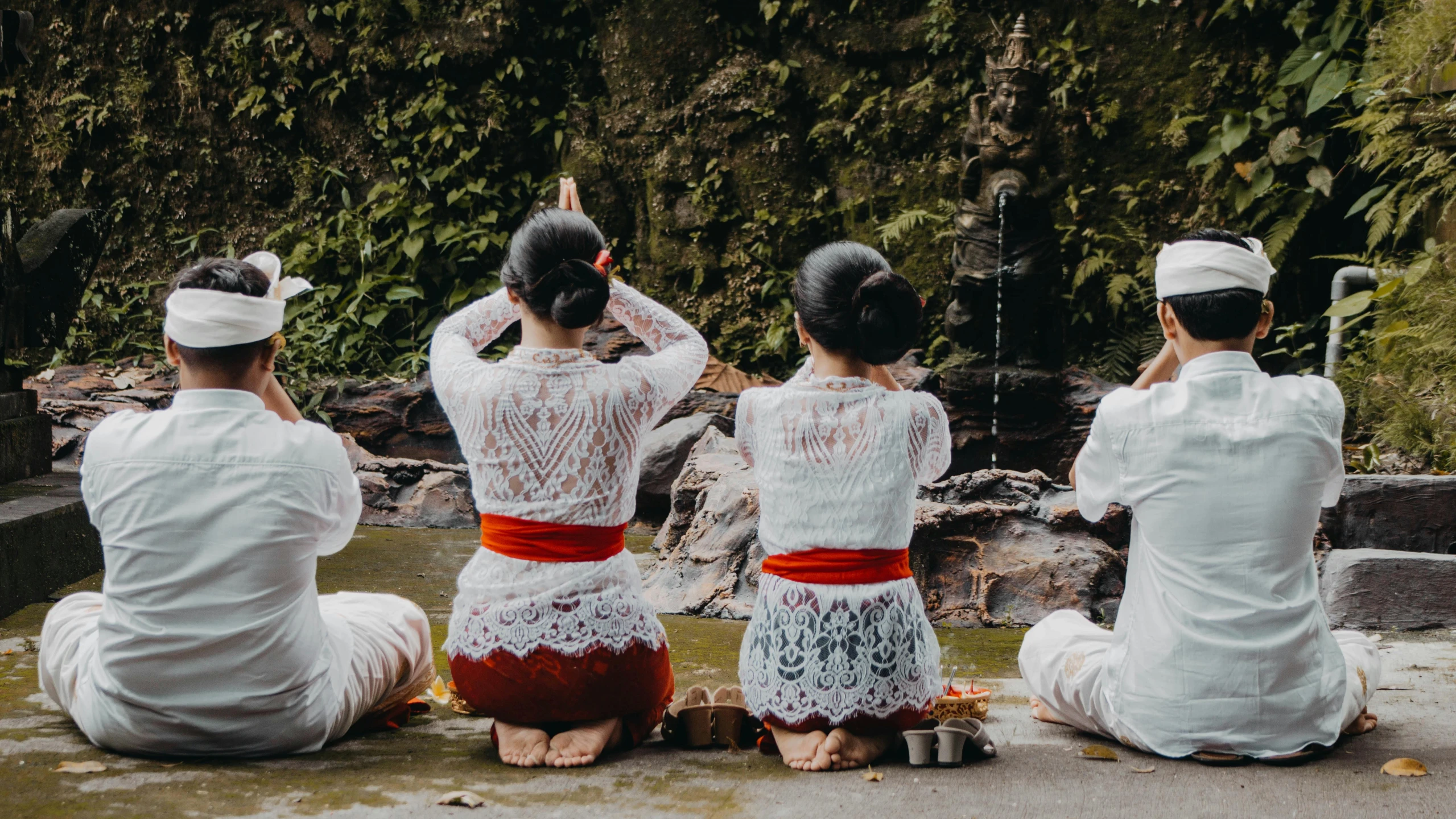 a group of people are sitting on the ground