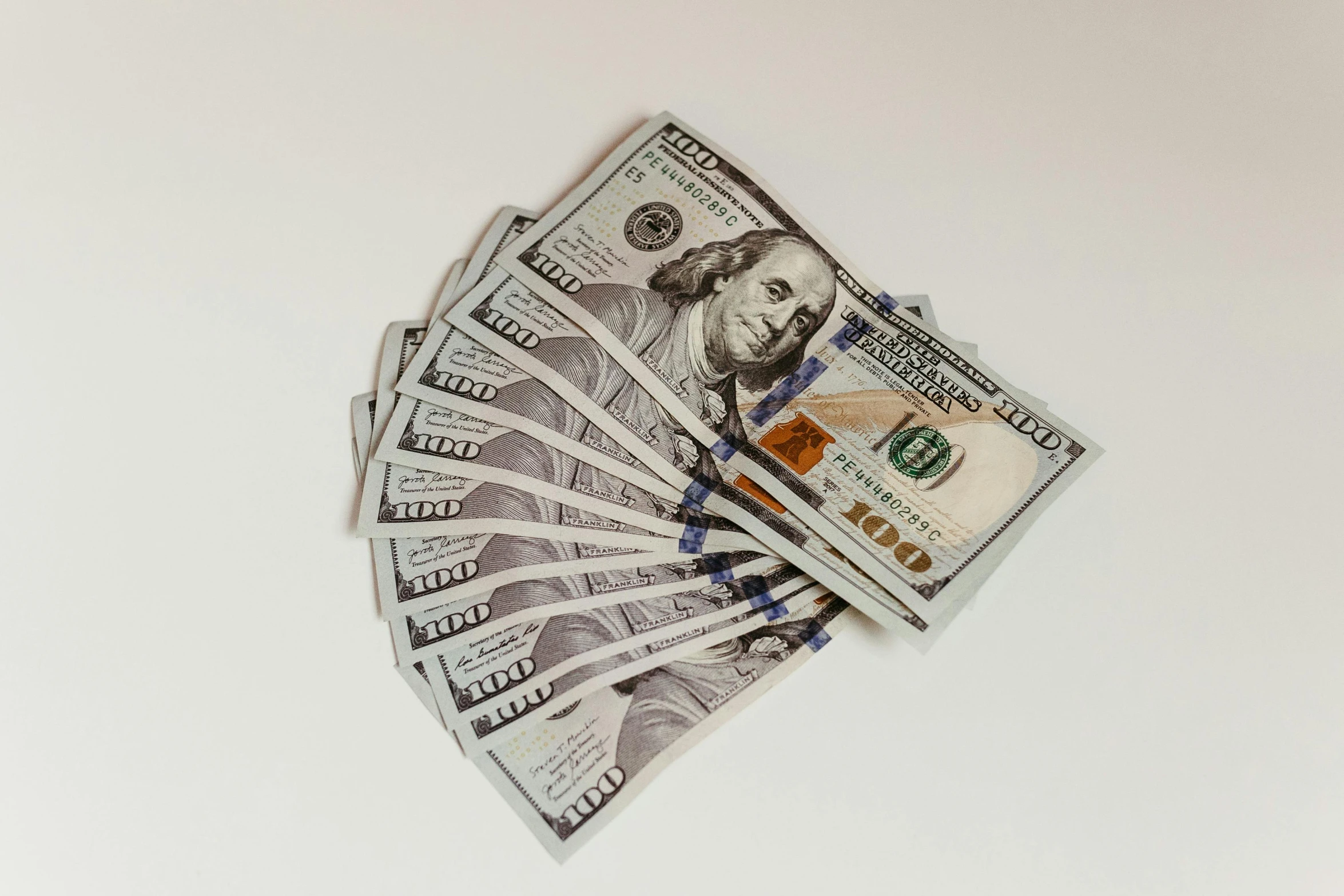 a pile of american currency against a white background