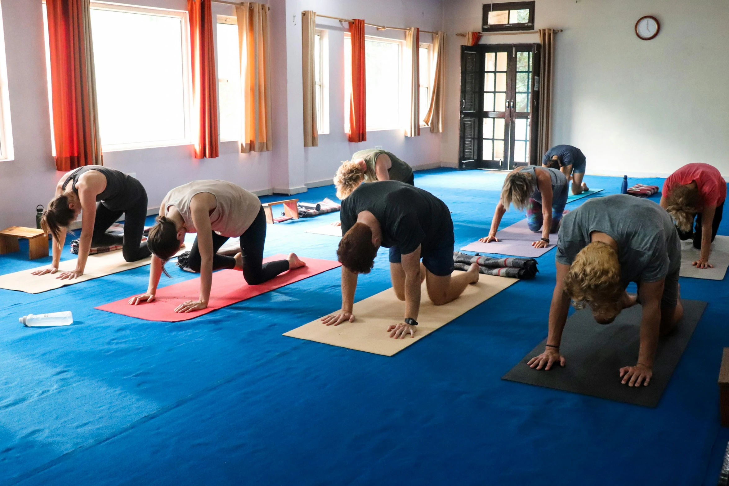 the people are doing yoga and stretching together