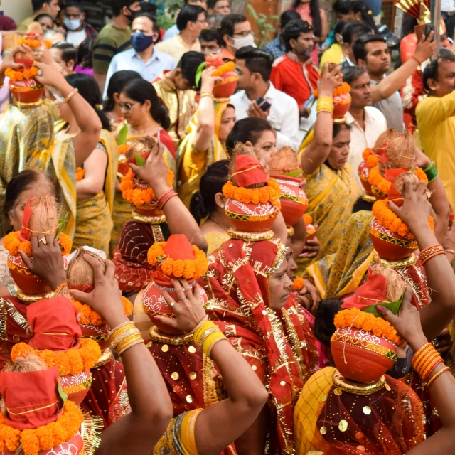 indian men dressed in bright red and yellow are lined up