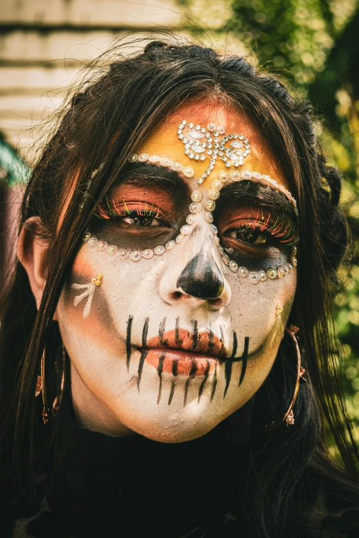 woman with painted skull and makeup all over her face