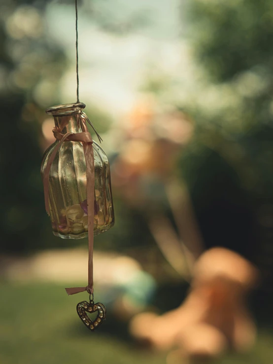 an insect shaped jar hanging on a string