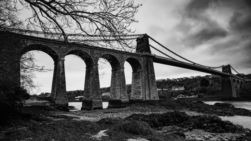 a black and white po of a bridge on an overcast day