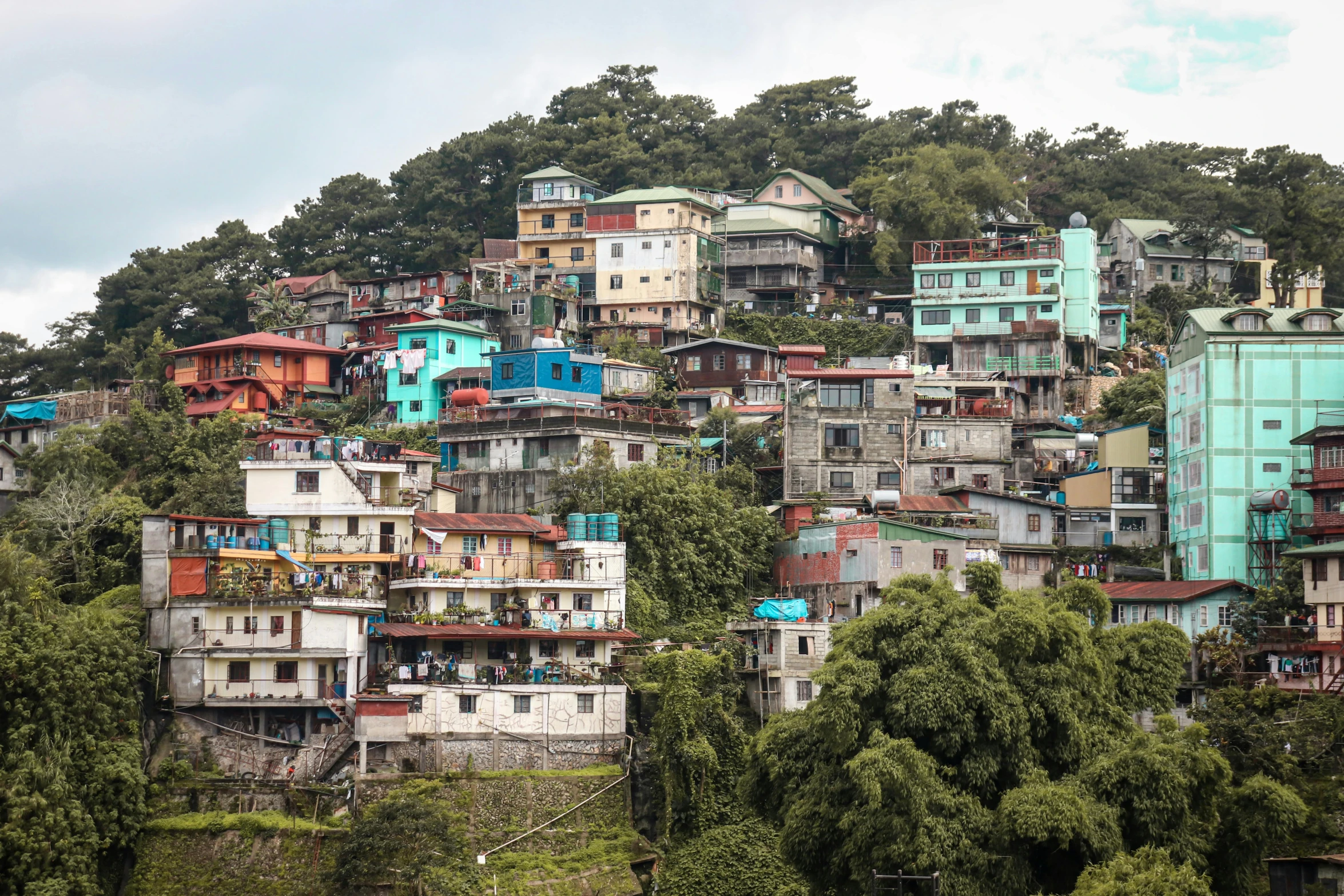 a colorful neighborhood in a city nestled on a mountain