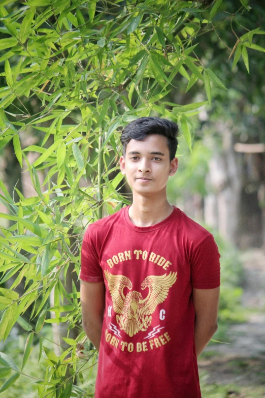  standing under a tree next to a dirt path