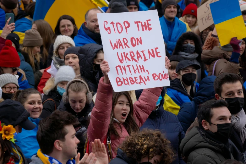 people are holding up a sign during a protest