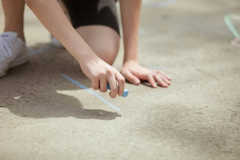 a person bending over and touching soing on the ground