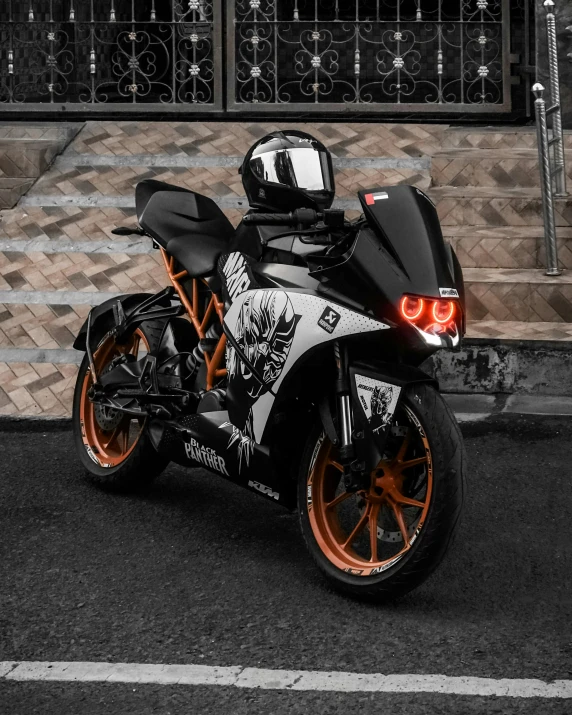 the motorcycle is painted black, orange and white