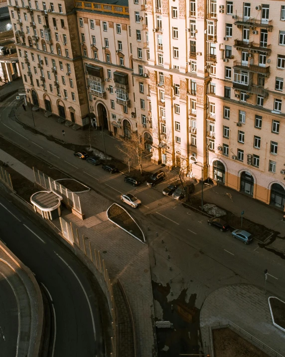 an old apartment building near a street and a parking lot