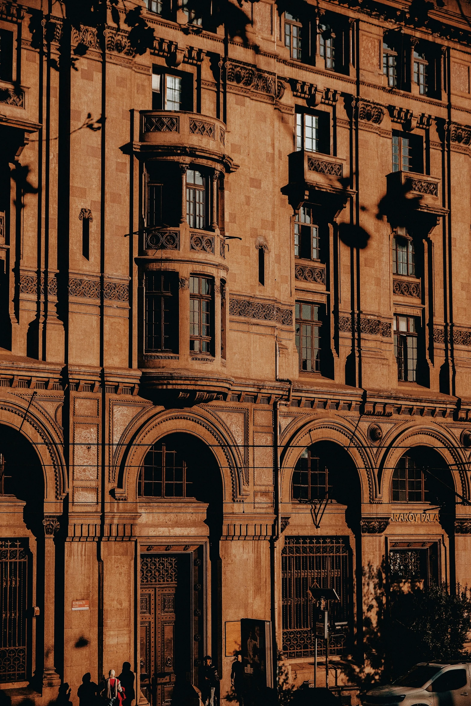 an old building that has some people on it