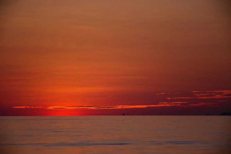 sunset over calm ocean from a distance