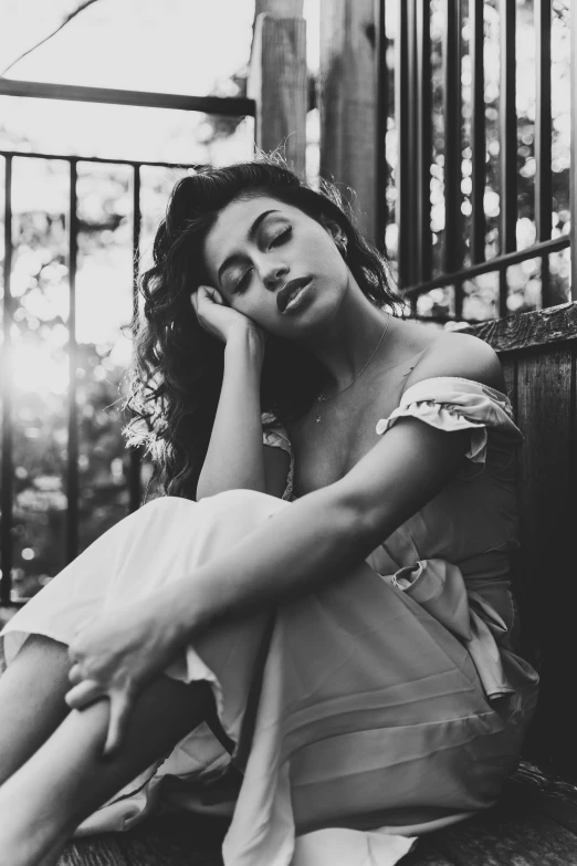 a woman is posing in a black and white image