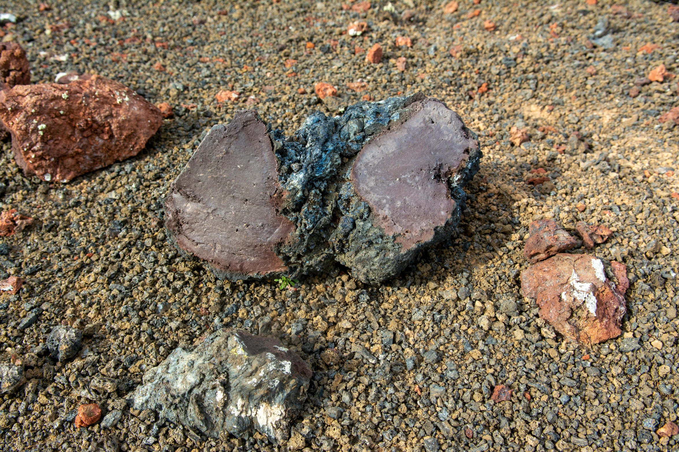 a trio of rocks sitting on top of dirt